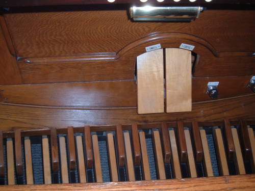 Pedals and swell and crescendo of the pipe organ.
