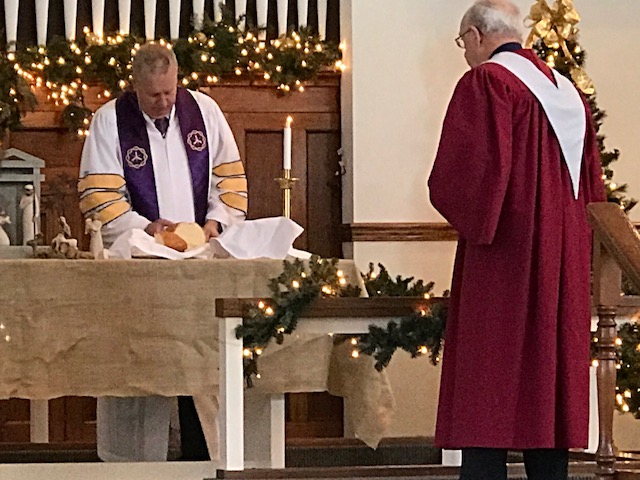 The pastor prepares Communion at the Paoli United Methodist Church during a Sunday morning worship service.