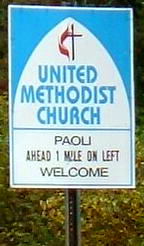 Highway sign: Paoli United Methodist Church 1 mile ahead on the left, Welcome!