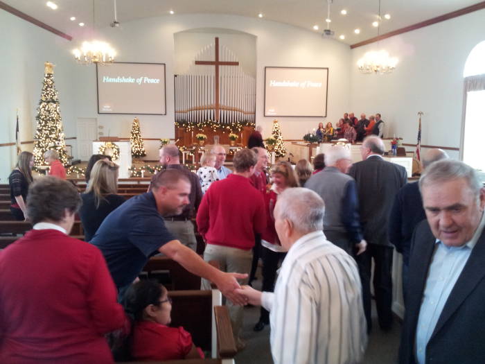 Passing a sign of peace during the service at the Paoli United Methodist Church.