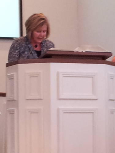 Dee Ann Harmon reads scripture during a worship service at the Paoli United Methodist Church.