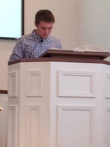Connor Henderson reads scripture during a worship service at the Paoli United Methodist Church.