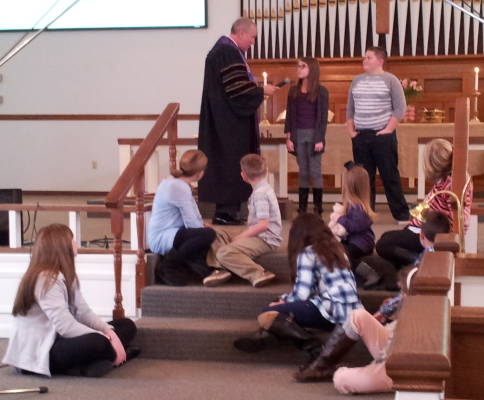Pastor LaMont with children during the Sunday morning worship service.
