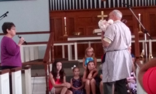 Donna Bonath and Howard Detweiler with children during the Sunday morning worship service.