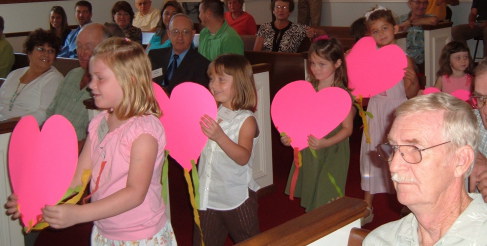 Children entering the United Methodist Church at the start of worship service.