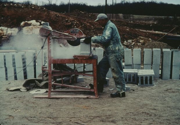 Lester Sturm cutting concrete blocks with a rotory saw.