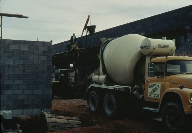 Concrete mixer truck delivers concrete to the construction site.