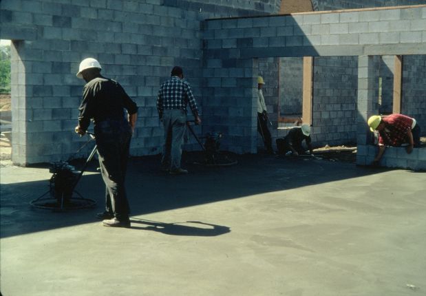 Men finishing a concrete floor.