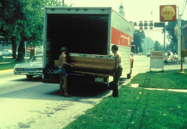 Men loading furniture into a moving van, moving out of the old Methodist Church building in Paoli, Indiana.