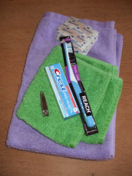 Hygiene kit collected by Paoli United Methodist Church: one hand towel, one washcloth, toothbrush, toothpaste, 6 Band-Aids, nail clipper, and comb.