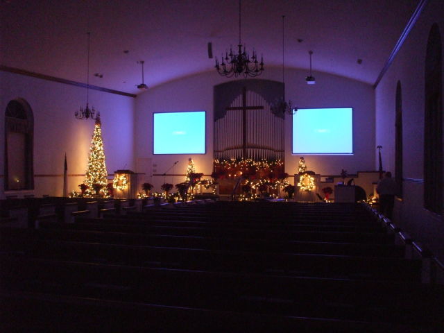 Christmas lights illuminate the church chancel.