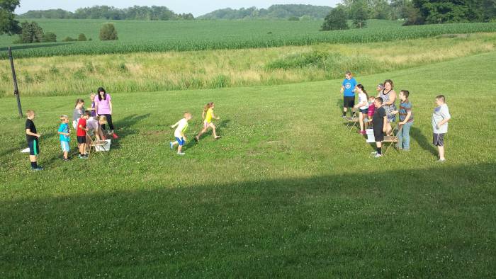 Children race outdoors at Paoli United Methodist Church Vacation Bible School.