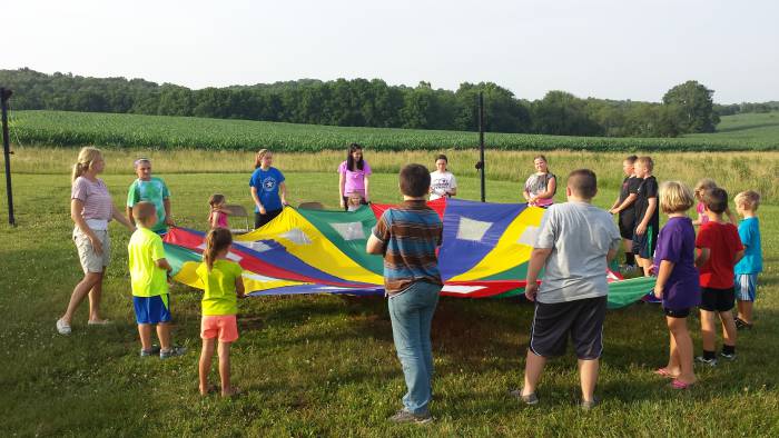 Children playing with a parachute at Paoli United Methodist Church Vacation Bible School.