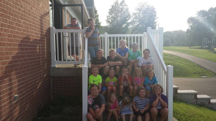 Children sitting on a staircase at Paoli United Methodist Church Vacation Bible School.