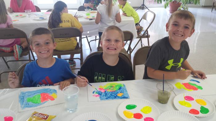 Children doing colorful crafts at Paoli United Methodist Church Vacation Bible School.