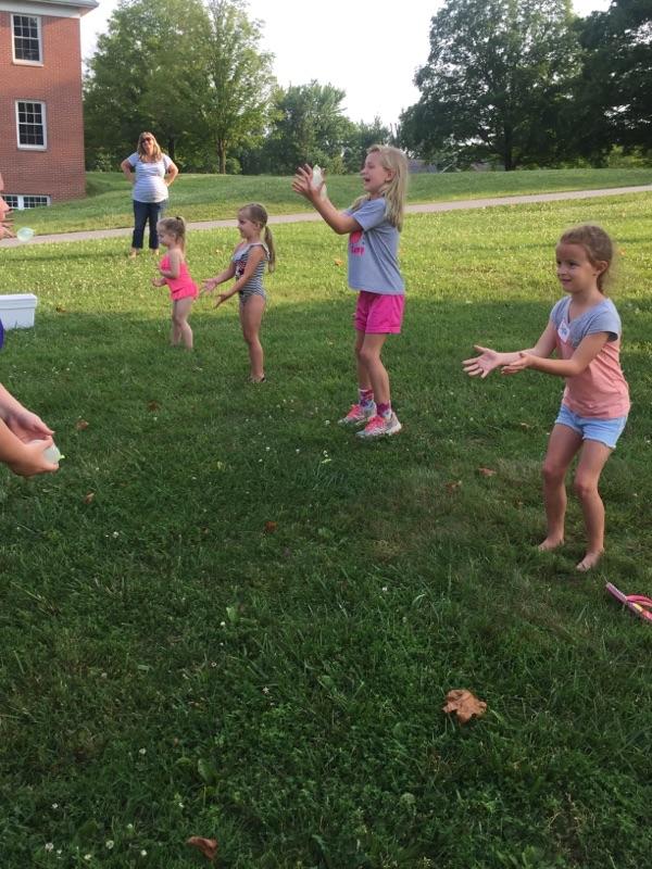 Children throwing water balloons at Vacation Bible School.